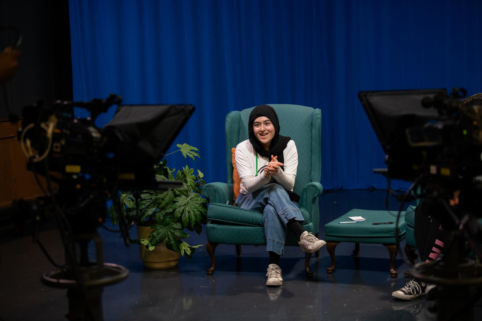 Student sitting in broadcasting studio